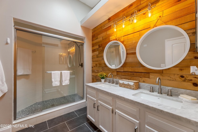 full bathroom with wood walls, a sink, and a stall shower
