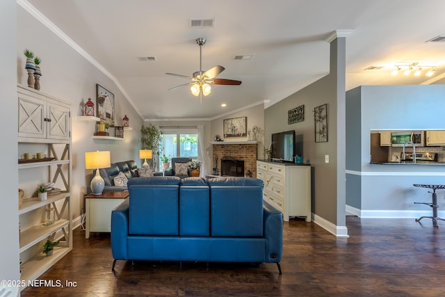 living room with dark wood finished floors, visible vents, crown molding, and ceiling fan