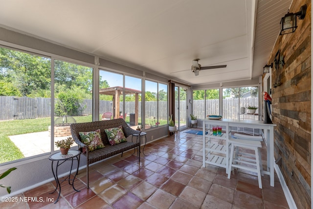 sunroom with a wealth of natural light and ceiling fan