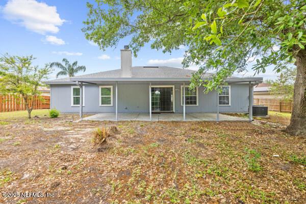 11978 Canterwood Dr, Jacksonville, FL 32246 - rear view of house with a patio area, central AC, fence, and a chimney