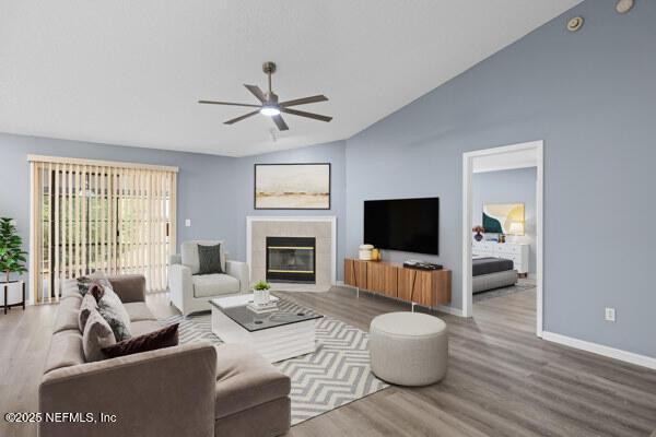 11978 Canterwood Dr, Jacksonville, FL 32246 - living area featuring wood finished floors, a fireplace, a ceiling fan, and lofted ceiling