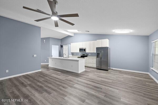 11978 Canterwood Dr, Jacksonville, FL 32246 - kitchen with lofted ceiling, baseboards, white cabinetry, ceiling fan, and stainless steel appliances