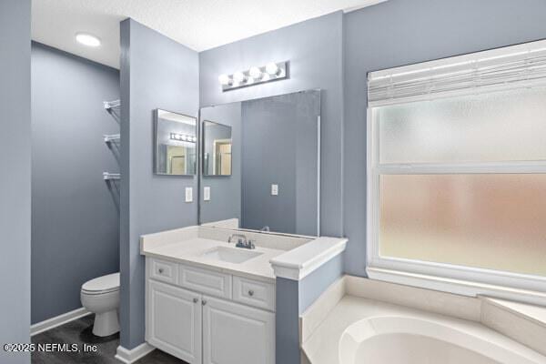 11978 Canterwood Dr, Jacksonville, FL 32246 - bathroom with vanity, a bath, baseboards, and toilet
