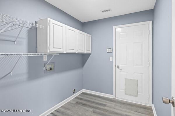 11978 Canterwood Dr, Jacksonville, FL 32246 - washroom featuring wood finished floors, washer hookup, baseboards, and cabinet space