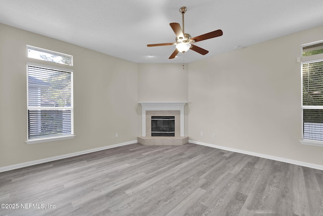 2395 Watermill Dr, Orange Park, FL 32073 - unfurnished living room featuring wood finished floors, a fireplace, a ceiling fan, and baseboards
