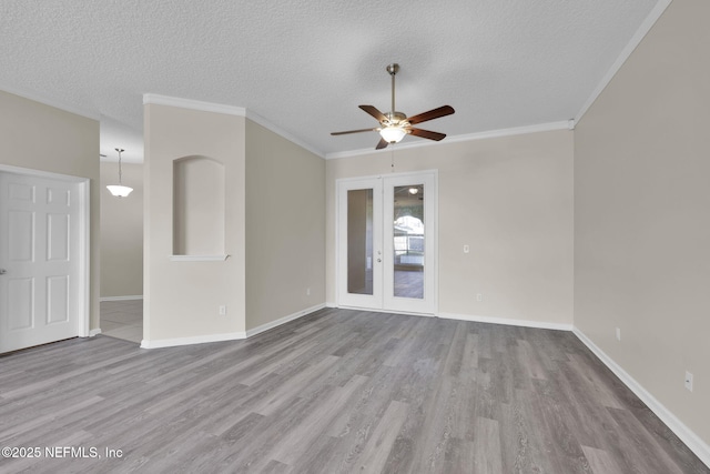 2395 Watermill Dr, Orange Park, FL 32073 - spare room featuring baseboards, ceiling fan, a textured ceiling, wood finished floors, and french doors