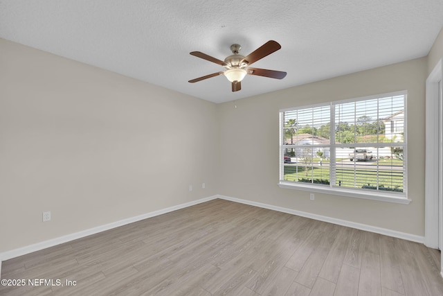 2395 Watermill Dr, Orange Park, FL 32073 - empty room with a textured ceiling, light wood finished floors, baseboards, and a ceiling fan