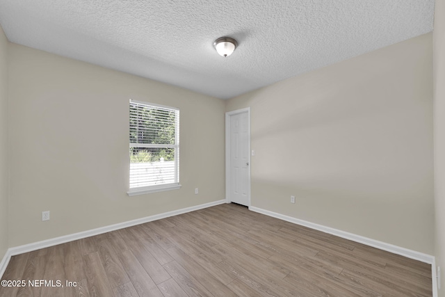 2395 Watermill Dr, Orange Park, FL 32073 - unfurnished room with baseboards, wood finished floors, and a textured ceiling
