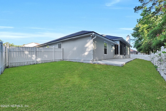 2395 Watermill Dr, Orange Park, FL 32073 - back of property with a patio area, a fenced backyard, a lawn, and a chimney