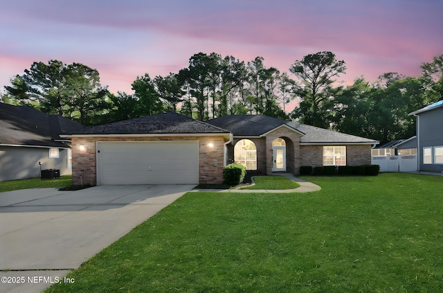 2395 Watermill Dr, Orange Park, FL 32073 - ranch-style home with driveway, an attached garage, central AC, a yard, and fence
