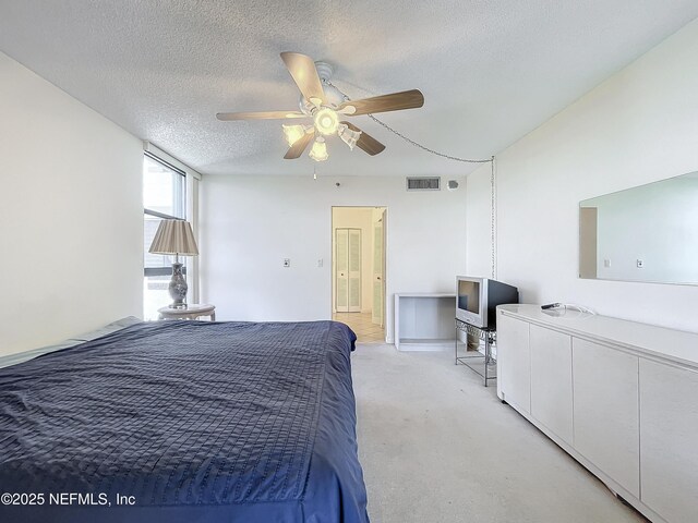 20225 NE 34th Ct Unit 817, Miami, FL 33810 - bedroom featuring light carpet, ceiling fan, visible vents, and a textured ceiling