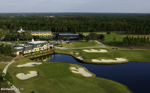 birds eye view of property with view of golf course, a water view, and a forest view
