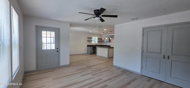1625 W 27th St, Jacksonville, FL 32209 - kitchen with light wood-style flooring, dark countertops, ceiling fan, recessed lighting, and a textured ceiling