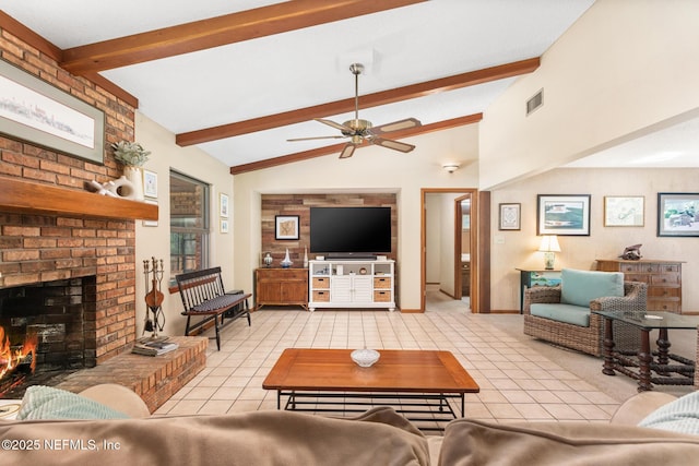 living area featuring lofted ceiling with beams, a fireplace, light tile patterned floors, visible vents, and ceiling fan