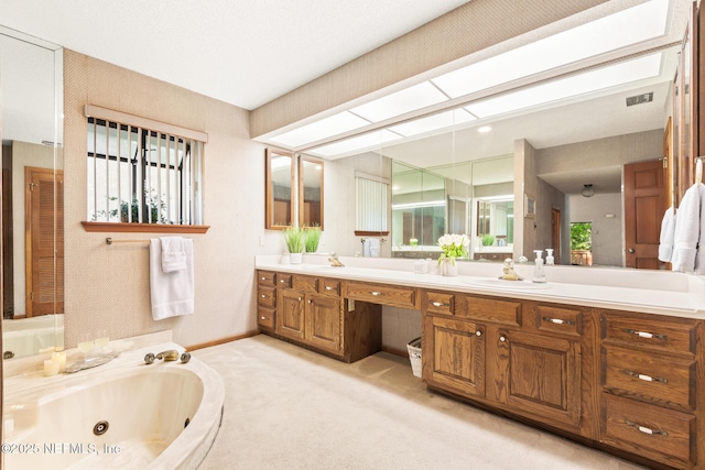 full bathroom featuring visible vents, baseboards, a sink, double vanity, and a jetted tub