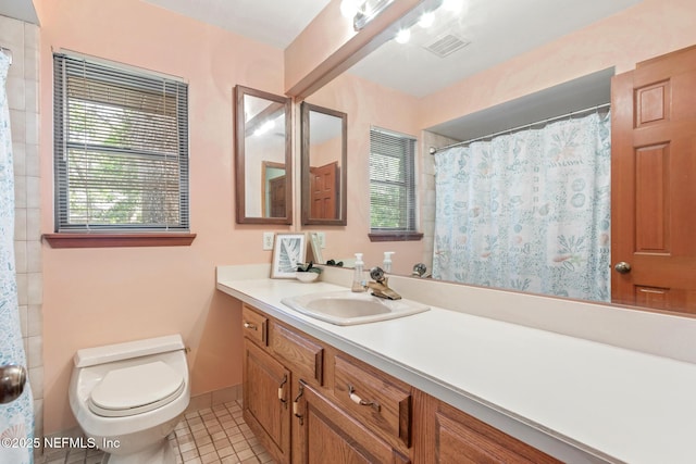 full bathroom with visible vents, baseboards, toilet, vanity, and tile patterned floors