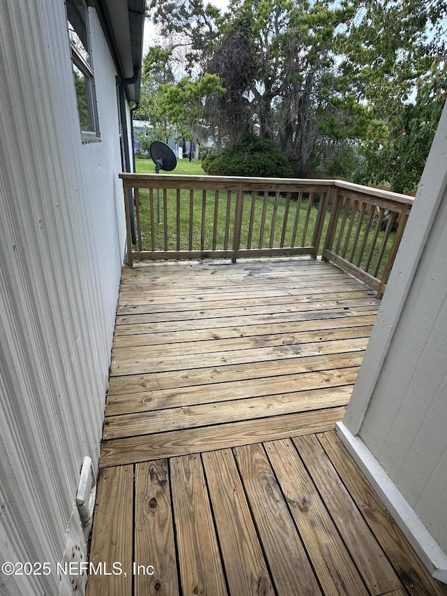 wooden deck with a lawn