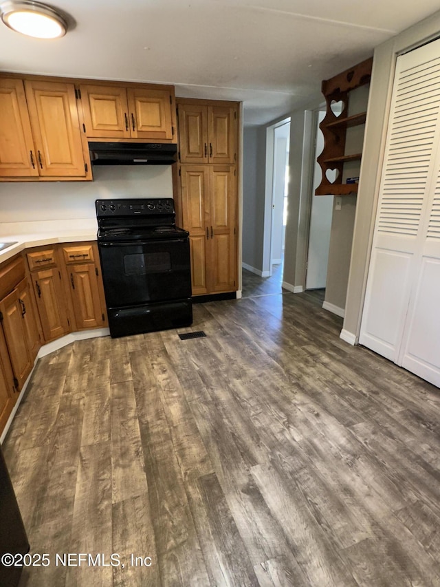 kitchen featuring dark wood-style floors, black range with electric stovetop, and under cabinet range hood