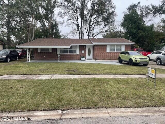 4123 Piper Dr, Jacksonville, FL 32207 - single story home with covered porch, a front yard, and brick siding