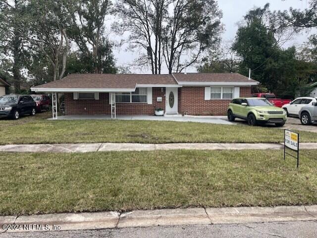 4123 Piper Dr, Jacksonville, FL 32207 - ranch-style house featuring brick siding, a front lawn, and a porch
