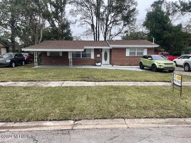 4123 Piper Dr, Jacksonville, FL 32207 - ranch-style house with a front yard, brick siding, and covered porch