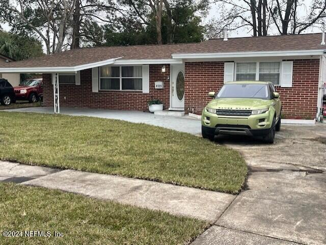 4123 Piper Dr, Jacksonville, FL 32207 - ranch-style home with brick siding and a front lawn