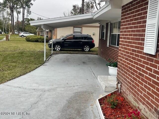 4123 Piper Dr, Jacksonville, FL 32207 - view of parking / parking lot with concrete driveway and an attached carport