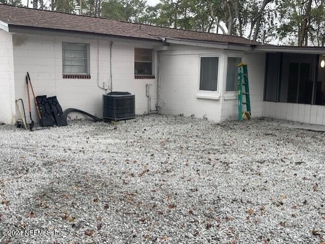4123 Piper Dr, Jacksonville, FL 32207 - rear view of house with concrete block siding and central air condition unit