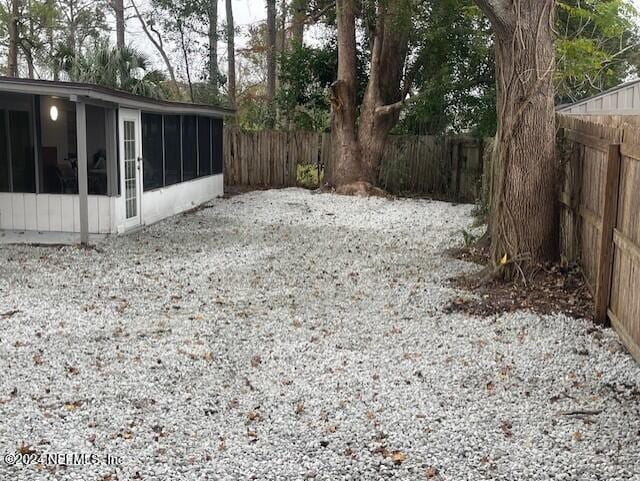 4123 Piper Dr, Jacksonville, FL 32207 - view of yard featuring a sunroom and a fenced backyard