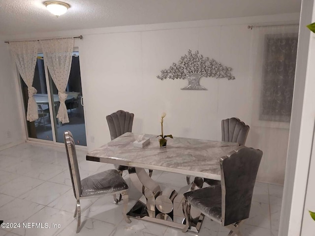 4123 Piper Dr, Jacksonville, FL 32207 - dining area with marble finish floor and a textured ceiling
