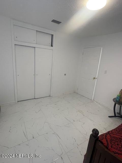4123 Piper Dr, Jacksonville, FL 32207 - bedroom with a closet, marble finish floor, and visible vents