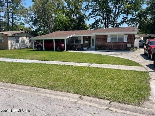 4123 Piper Dr, Jacksonville, FL 32207 - single story home featuring a front yard, driveway, brick siding, and a carport