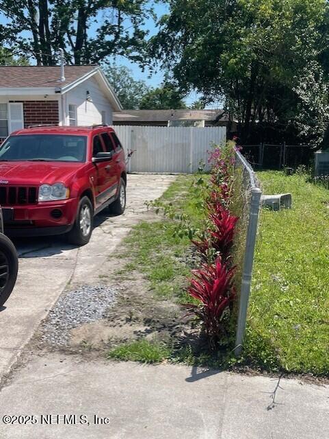 4123 Piper Dr, Jacksonville, FL 32207 - view of yard featuring driveway and fence