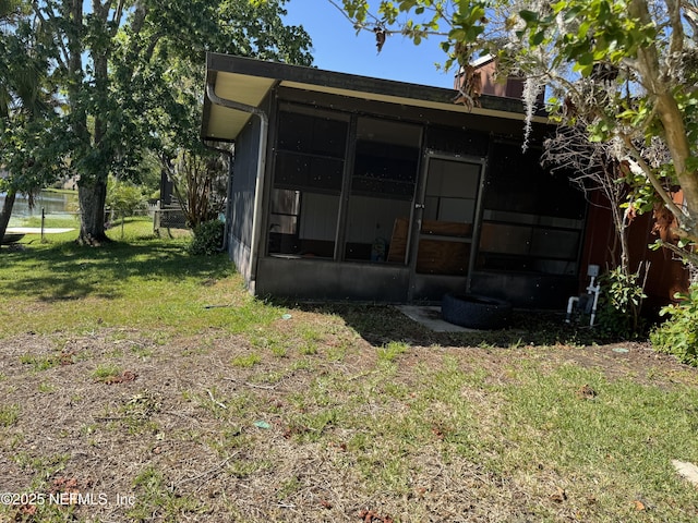 1717 Derringer Rd, Jacksonville, FL 32225 - rear view of house featuring a lawn, fence, and a sunroom