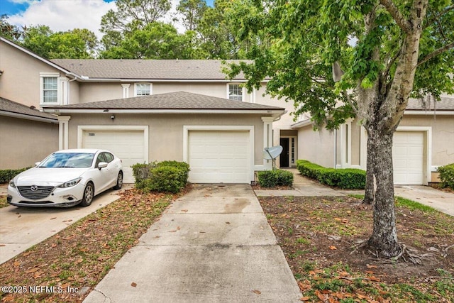 7831 Melvin Rd Unit 1, Jacksonville, FL 32210 - view of property with concrete driveway, stucco siding, and a garage