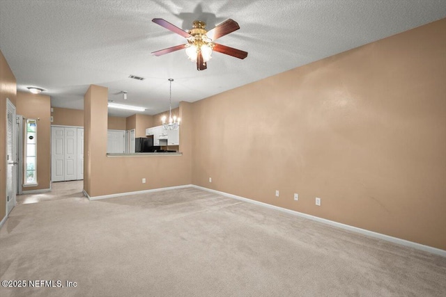 7831 Melvin Rd Unit 1, Jacksonville, FL 32210 - unfurnished living room featuring visible vents, baseboards, a textured ceiling, ceiling fan with notable chandelier, and light colored carpet