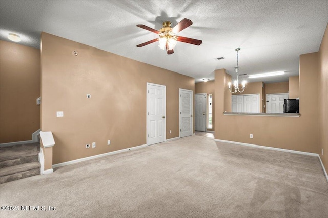 7831 Melvin Rd Unit 1, Jacksonville, FL 32210 - carpeted empty room with visible vents, baseboards, a textured ceiling, stairway, and ceiling fan with notable chandelier