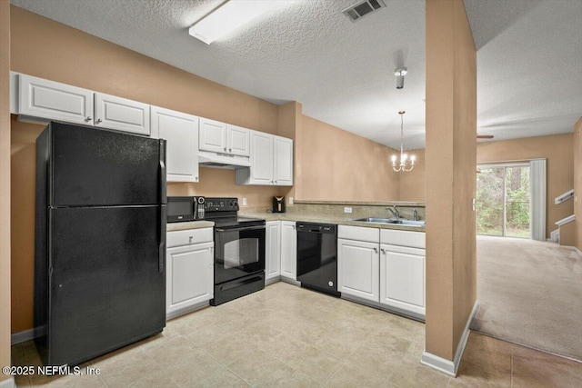 7831 Melvin Rd Unit 1, Jacksonville, FL 32210 - kitchen with white cabinets, under cabinet range hood, black appliances, visible vents, and a sink