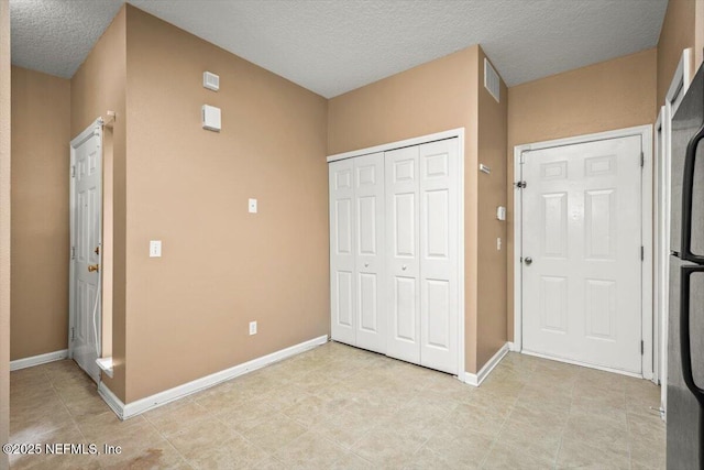 7831 Melvin Rd Unit 1, Jacksonville, FL 32210 - unfurnished bedroom with a closet, visible vents, a textured ceiling, and baseboards