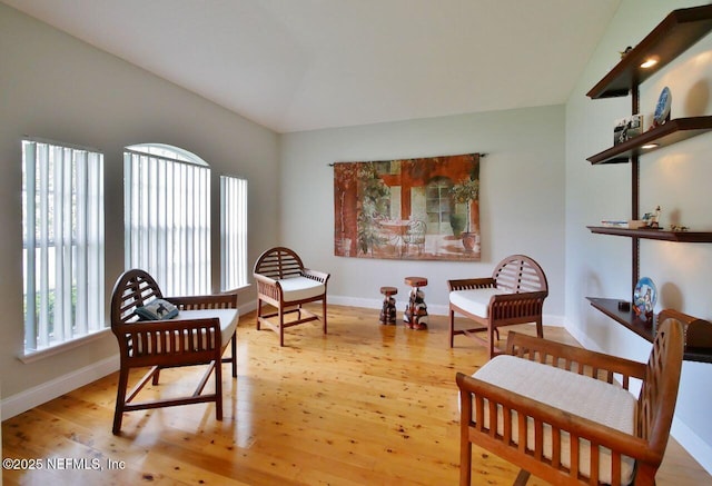 2612 S Waterleaf Dr, Saint Augustine, FL 32092 - sitting room with baseboards, light wood-type flooring, and vaulted ceiling