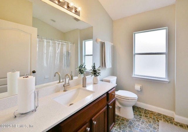 2612 S Waterleaf Dr, Saint Augustine, FL 32092 - full bathroom with vanity, toilet, baseboards, vaulted ceiling, and curtained shower