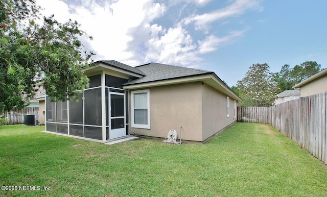 2612 S Waterleaf Dr, Saint Augustine, FL 32092 - rear view of house featuring a sunroom, stucco siding, cooling unit, and roof with shingles