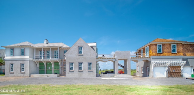 view of front of property featuring a garage, a chimney, and stucco siding