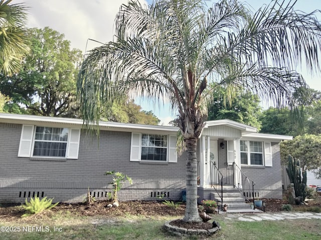 512 Clinton Dr, Orange Park, FL 32073 - view of front facade with crawl space and brick siding