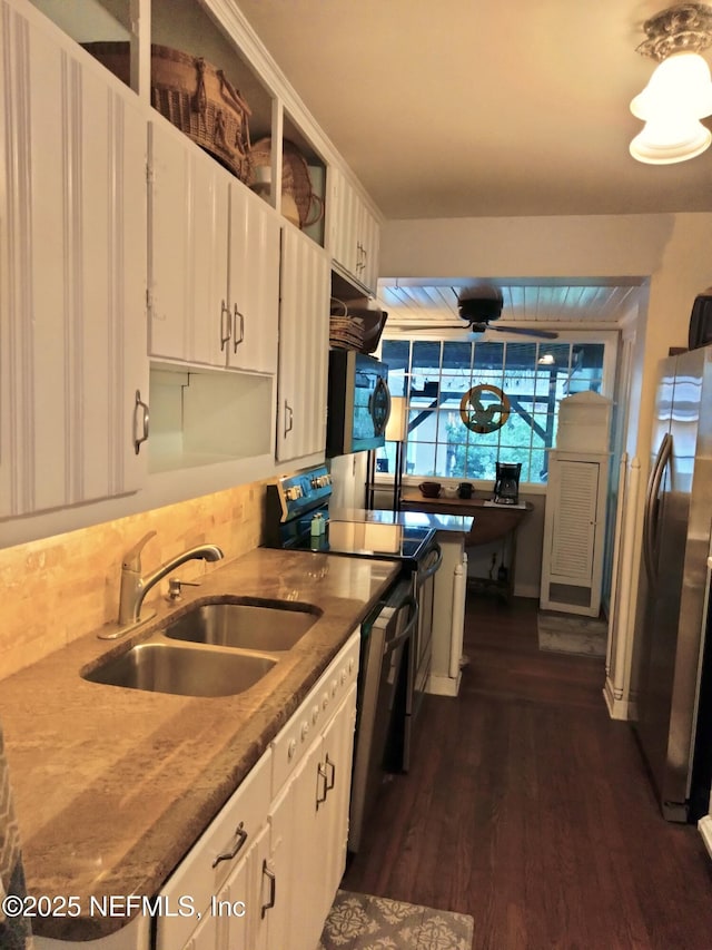 512 Clinton Dr, Orange Park, FL 32073 - kitchen featuring a sink, stainless steel appliances, white cabinetry, tasteful backsplash, and dark wood-style flooring