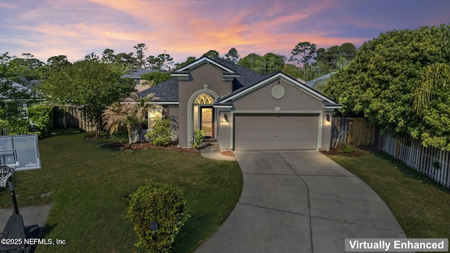 view of front of house with a garage, fence, stucco siding, a front lawn, and driveway