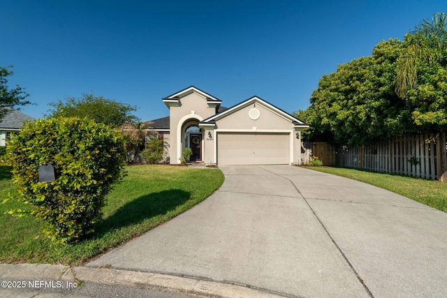 single story home featuring concrete driveway, stucco siding, a front yard, a garage, and fence