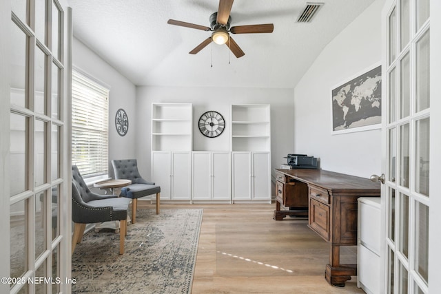 office featuring french doors, ceiling fan, vaulted ceiling, and visible vents