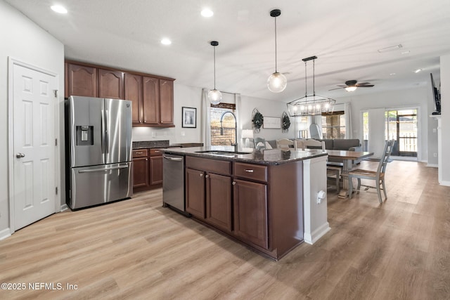 kitchen with recessed lighting, light wood-style floors, a sink, and appliances with stainless steel finishes