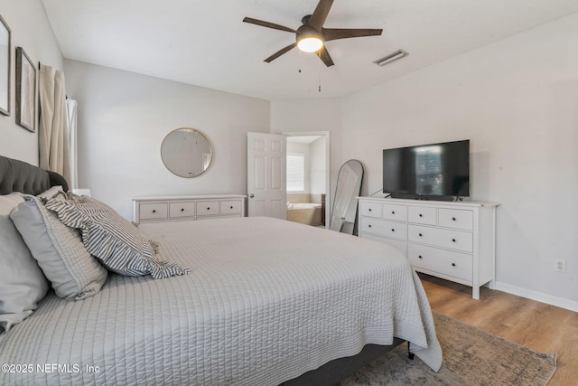 bedroom featuring light wood finished floors, visible vents, baseboards, and ceiling fan